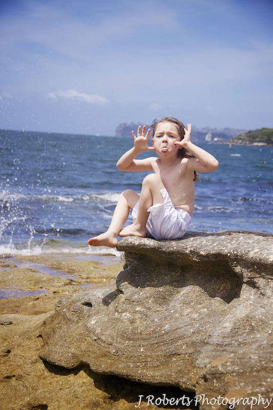 Little girl making faces at the beach - family portrait photography sydney